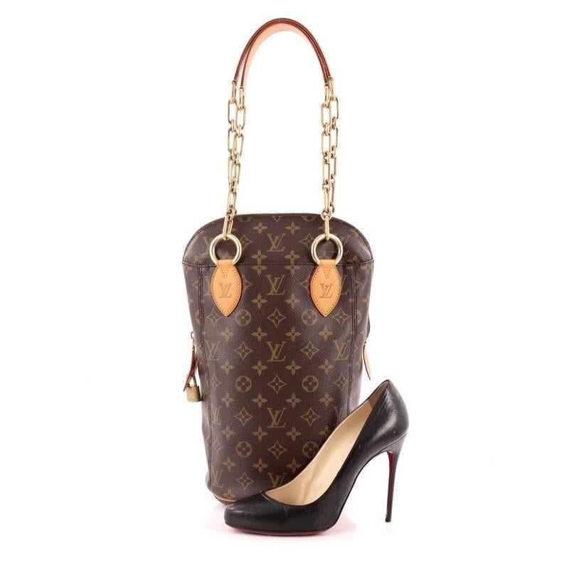 This authentic Louis Vuitton Punching Bag Monogram Canvas PM is a collaboration piece from Karl Lagerfeld, Rei Kawakubo, Marc Newsom, Cindy Sherman, Frank Gehry, and Christian Louboutin that combines the concepts of sport and luxury. Crafted from