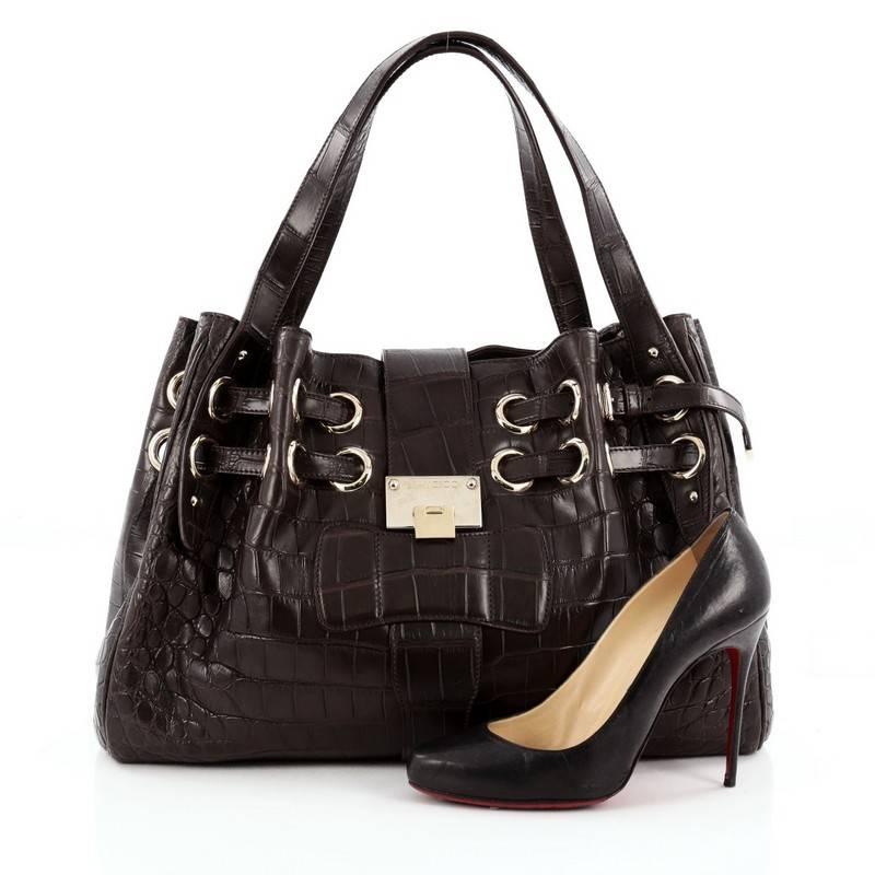 This authentic Jimmy Choo Ramona Hobo Crocodile is sophisticated and easy-to-carry made for everyday excursions. Constructed from brown genuine crocodile skin, this hobo features multiple wrapped slim straps laced through metal eyelets, dual flat