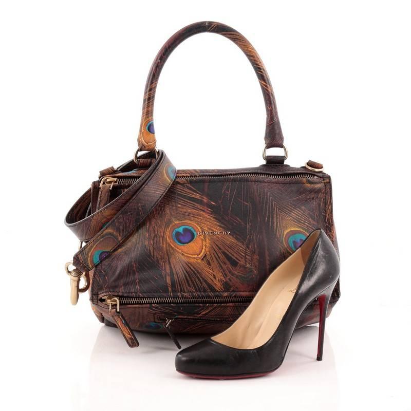 This authentic Givenchy Pandora Bag Printed Leather Medium is an easy to carry, everyday crossbody that is both stylish and functional. Constructed from stand-out peacock feathers print leather, this version of Givenchy's popular pandora bag