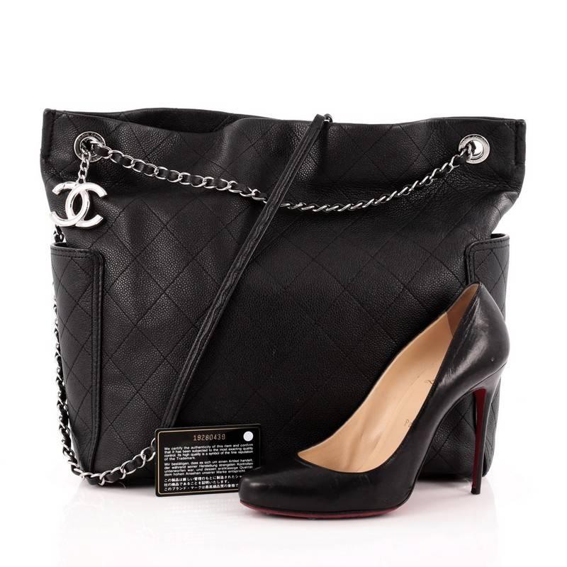 This authentic Chanel CC Pocket Tote Quilted Caviar Medium is the perfect luxe companion for the modern woman. Crafted in black quilted caviar leather, this simple yet elegant tote features woven-in leather chain straps, exterior side pockets, CC