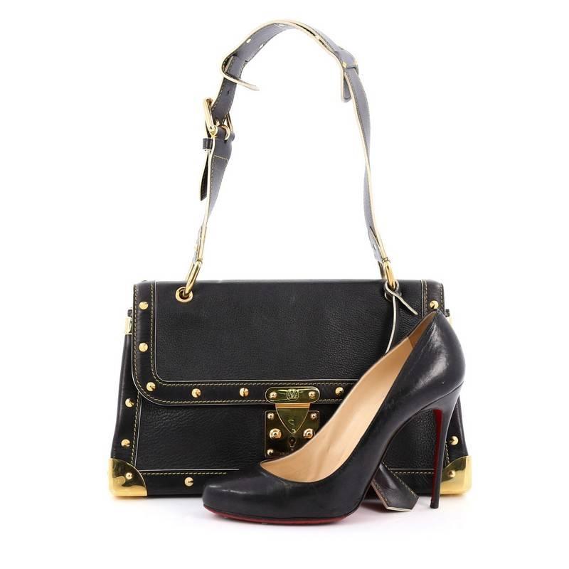 This authentic Louis Vuitton Suhali Le Talentueux Handbag Leather exudes an edgy-chic style perfect for everyday. Crafted from black leather, this stylish bag features an adjustable shoulder strap, gold-tone corner plates, stud detailing, stand-out