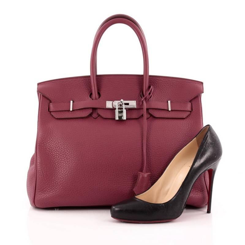 This authentic Hermes Birkin Handbag Rubis Clemence with Palladium Hardware 35 is synonymous to traditional Hermes luxury. Crafted with sturdy, scratch-resistant rubis red clemence leather, this eye-catching luxurious tote is accented with polished
