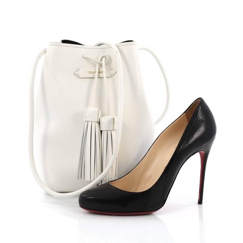 This authentic Tom Ford Tassel Bucket Bag Leather Small is a chic bucket bag perfect for on-the-go moments. Crafted from white leather, this sleek, understated bag features rolled crossbody strap, logo applique at center, tassel drawstring top