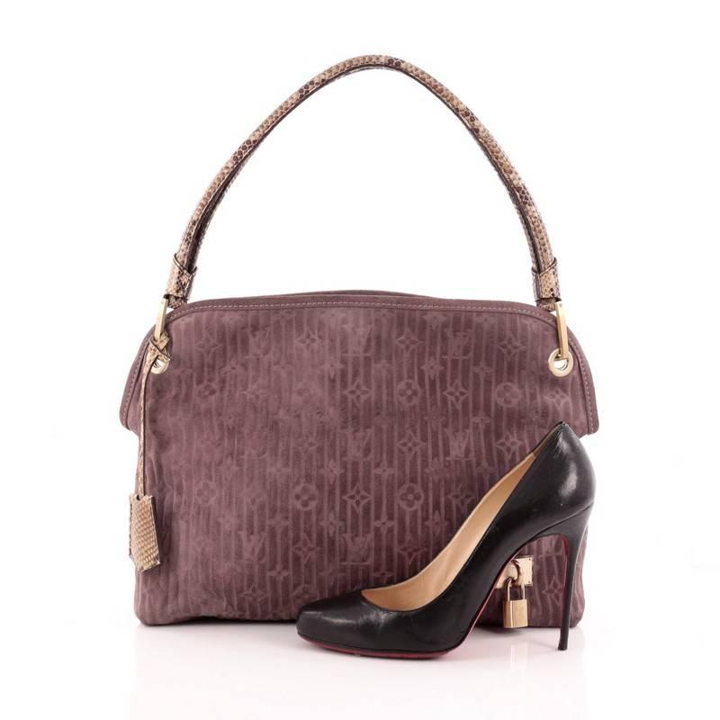 This authentic Louis Vuitton Limited Edition Whisper Bag Monogram Suede and Python PM is one of Marc Jacob's standouts from Louis Vuitton's Fall/Winter 2008 Collection. Crafted from purple embossed monogram suede with python trims, this practical