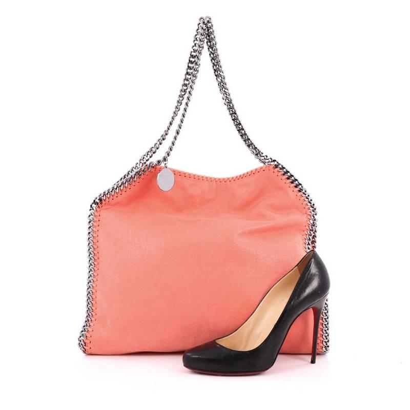 This authentic Stella McCartney Falabella Tote Shaggy Deer Small is perfect for casual day-to-day excursions. Crafted from coral shaggy deer leather, this no-fuss, lightweight tote features chrome chain link strap and trims, whipstitched edges,