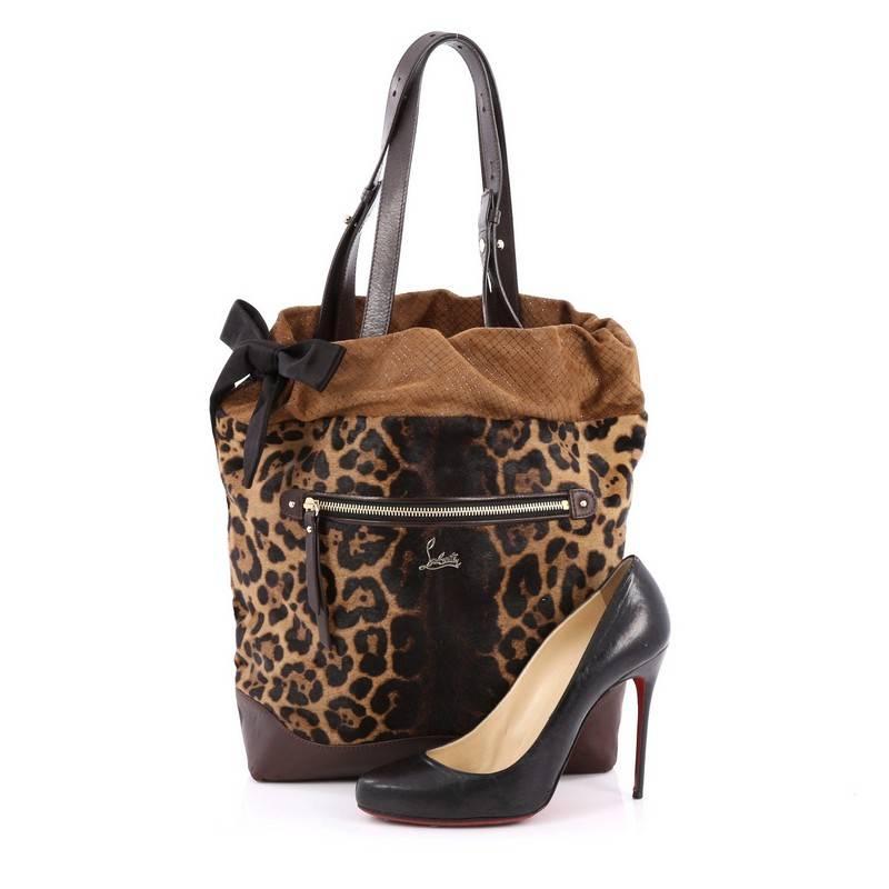 This authentic Christian Louboutin Pola Tote Printed Pony Hair with Leather and Suede is unique and stylish. Crafted in brown genuine pony hair in leopard print, this bucket features brown leather base, dual leather strap, drawstring black fabric,