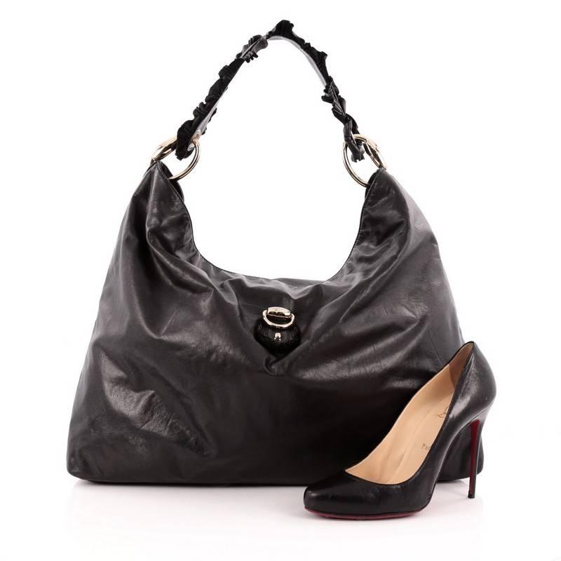 This authentic Gucci Sabrina Hobo Leather Large is perfect for everyday casual look. Crafted in black leather, this oversized hobo features looping ruched leather strap, Gucci ring logo and gold-tone hardware accents. It opens to a spacious black
