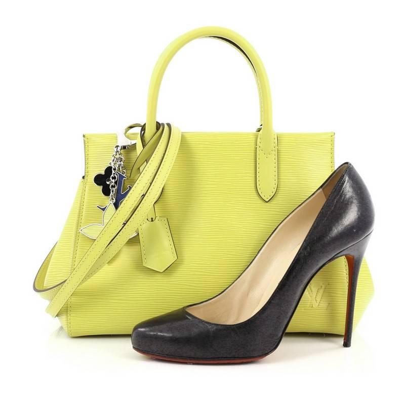This authentic Louis Vuitton Marly Handbag Epi Leather BB exudes casual sophistication perfect for the modern woman. Crafted in sturdy pistache yellow epi leather, this structured working tote features an angular silhouette, dual-rolled leather