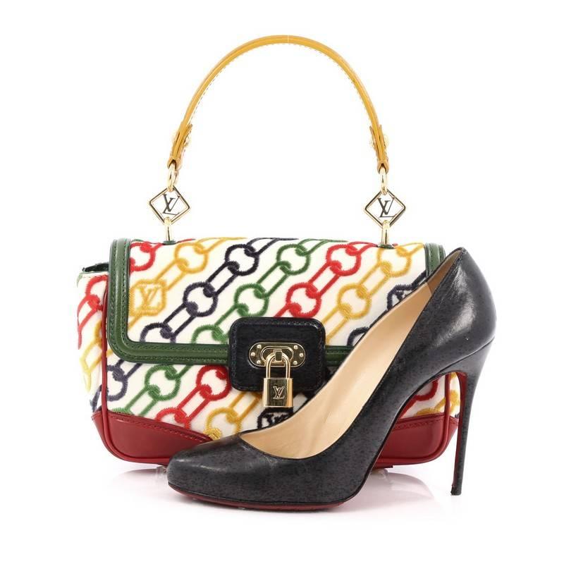 This authentic Louis Vuitton Limited Edition Dolly Handbag Velvet Chains with Leather is a luxurious bag perfect to add to your collection. Crafted from velvet printed colorful chains with multicolor leather trims, this bag features, top leather