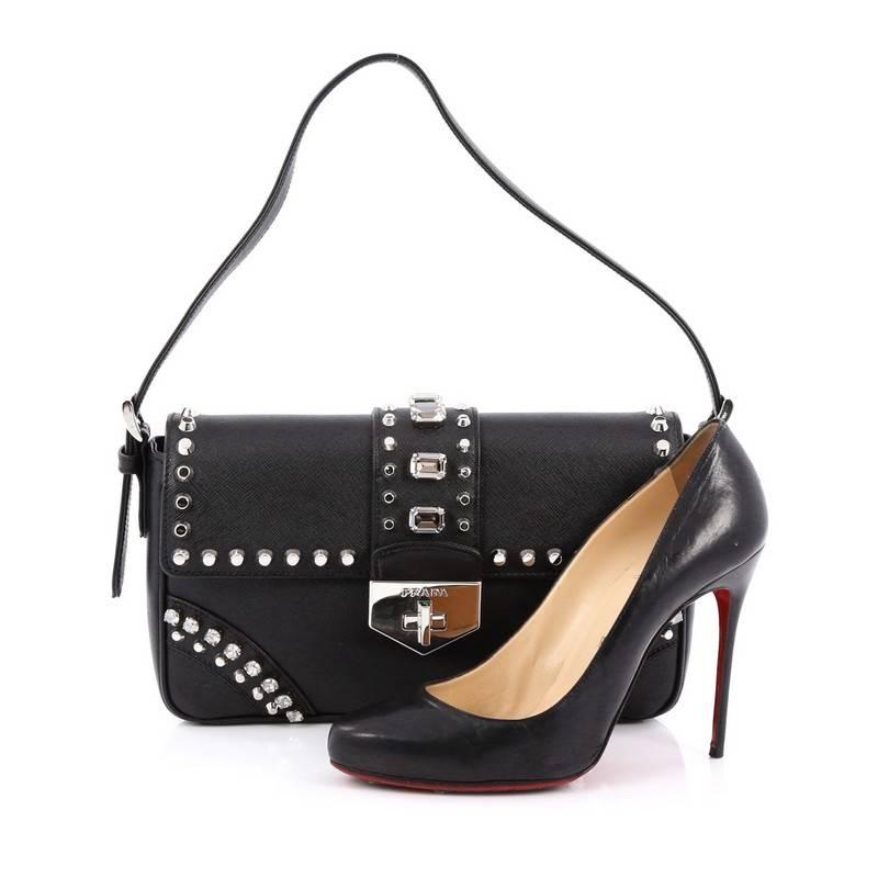 This authentic Prada Turnlock Flap Shoulder Bag Studded Saffiano Leather Medium is the perfect bag to pair for your day or night looks. Crafted from black saffiano leather, this bag features short adjustable leather handle, diamond and studs