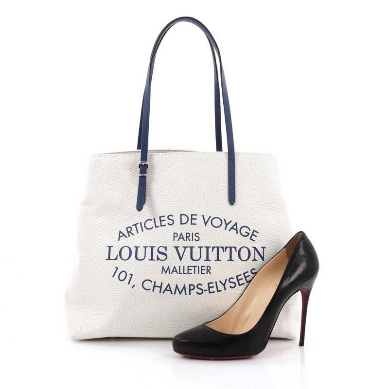 This authentic Louis Vuitton Limited Edition Articles de Voyage Cabas Canvas MM is perfect for summer getaways and light travels. Crafted in off-white canvas with voyage lettering, this tote features adjustable thin saphir blue leather straps, side