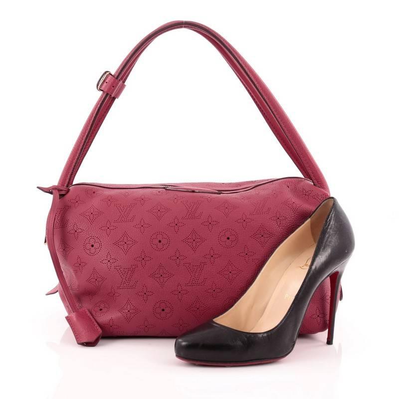 This authentic Louis Vuitton Galatea Handbag Mahina Leather PM released in the brand's 2011 Collection is a classic and feminine design meant to be adored like its namesake. Constructed in intricate perforated monogram in classic grenat red mahina