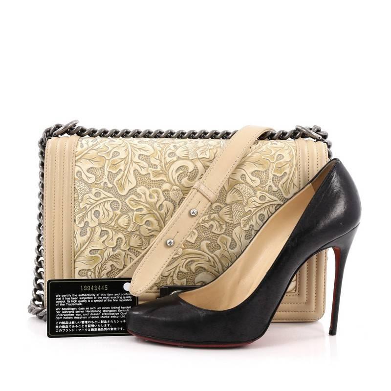 This authentic Chanel Cordoba Boy Flap Bag Leather New Medium presented in Paris-Dallas 2014 collection is unique and stylish bag from Chanel that will sure to turn heads. Crafted in decoratively embossed fall leaves framed by a linear quilting