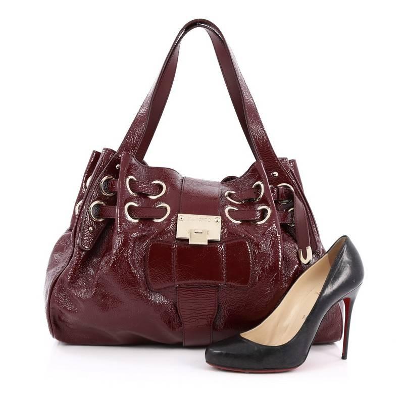 This authentic Jimmy Choo Ramona Hobo Patent is sophisticated and easy-to-carry made for everyday excursions. Constructed from burgundy patent, this hobo features multiple wrapped slim patent leather straps laced through metal eyelets, dual flat