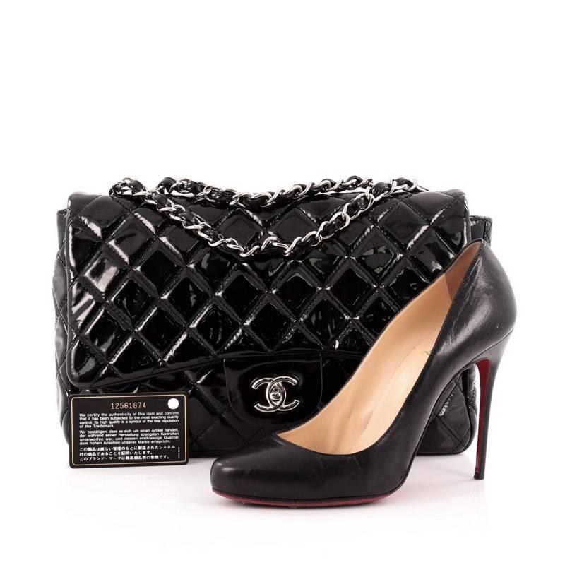 This authentic Chanel Classic Single Flap Bag Quilted Crinkled Patent Jumbo is a timeless essential for any modern woman. Crafted in black quilted crinkled patent leather, this classic flap features woven-in leather chain strap, exterior back
