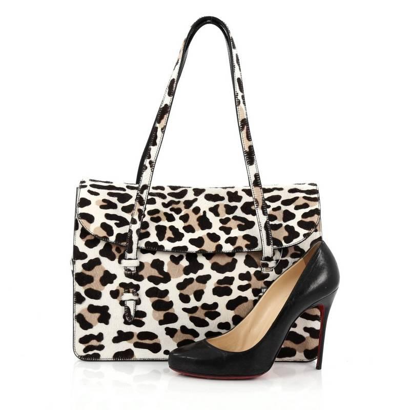 This authentic Alaia Flap Tote Bag Calf Hair Medium is unique and casual perfect for everyday use. Crafted in animal printed genuine calf hair, this tote features dual top handles, frontal flap, detachable pocket mirror and silver-tone hardware