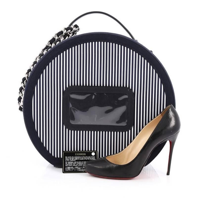 This authentic Chanel Hat Box Handbag Fabric is from the brands' 2010 Cruise Collection that is a collector's dream. Crafted from navy blue striped fabric with leather trims, this bag features looping top handle, woven-in leather chain ink strap
