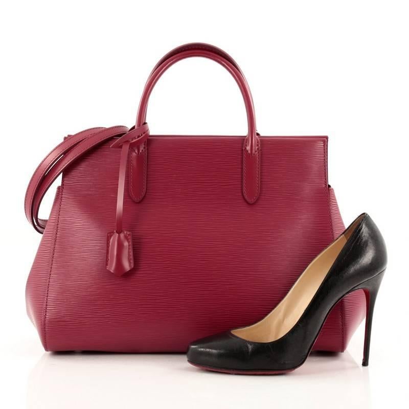 This authentic Louis Vuitton Marly Handbag Epi Leather MM presented in the brand's Spring/Summer 2014 Collection exudes casual sophistication with professional subtlety perfect for the modern woman. Crafted in sturdy fuchsia dark pink epi leather,
