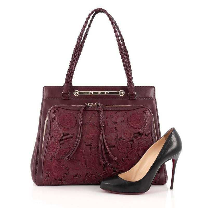 This authentic Valentino Demetra Tote Leather Lace showcases a chic and stylish design made for day-to-day excursions. Crafted in wine leather, this romantic, feminine tote features braided leather straps, a large front zip-around pocket with