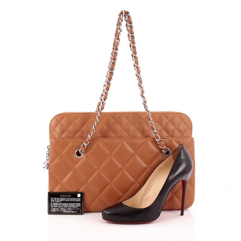 This authentic Chanel In The Business Camera Bag Quilted Calfskin Large is a classic and timeless piece perfect for your everyday use. Crafted from brown quilted calfskin leather, this bag features woven-in leather silver chain straps, silver CC