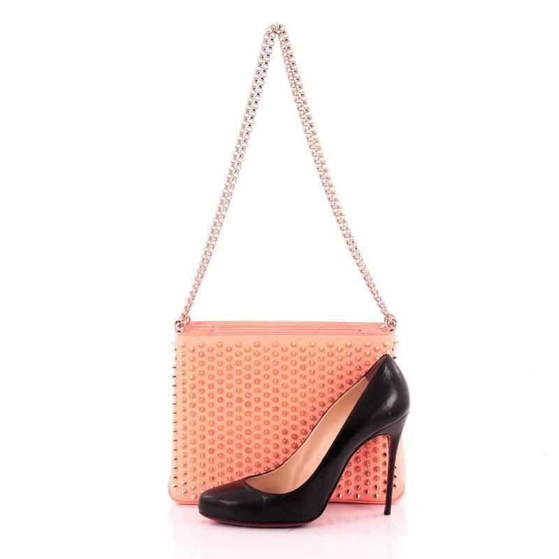 This authentic Christian Louboutin Triloubi Chain Bag Leather Large balances an edgy-chic design with feminine flair perfect for night outs. Crafted in gradient neon flamingo coral pink leather, this day-to-night chain bag features Louboutin's