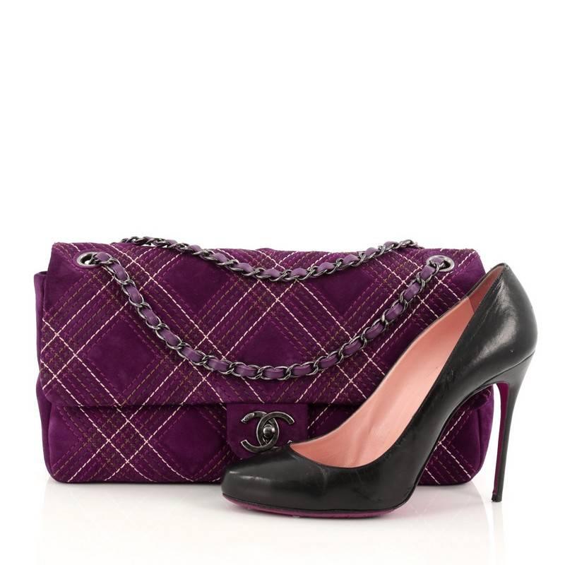 This authentic Chanel Saltire Flap Bag Stitched Suede Medium is ideal for night outs. Crafted in purple suede, this flap bag features contrasting diamond stitches in purple, green, brown and white colors, woven-in leather chain strap and gunmetal