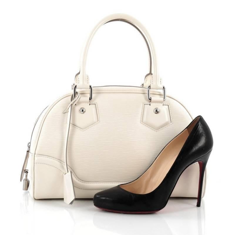 This authentic Louis Vuitton Montaigne Bowling Bag Epi Leather PM is perfect for everyday use. Crafted in ivorie white epi leather, this petite bowler features dual-rolled leather handles, protective base studs and silver-tone hardware accent. Its