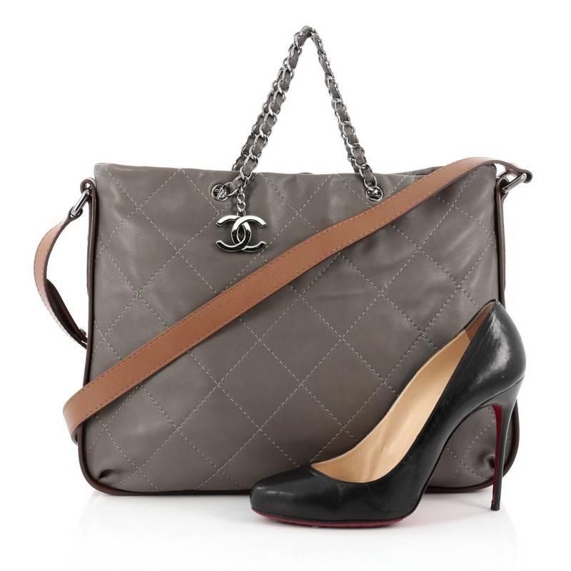 This authentic Chanel Country Chic Shoulder Bag Quilted Lambskin Large is the perfect luxe companion for the modern woman. Crafted in grey quilted lambskin leather, this simple yet elegant tote features woven-in leather chain handles, long leather