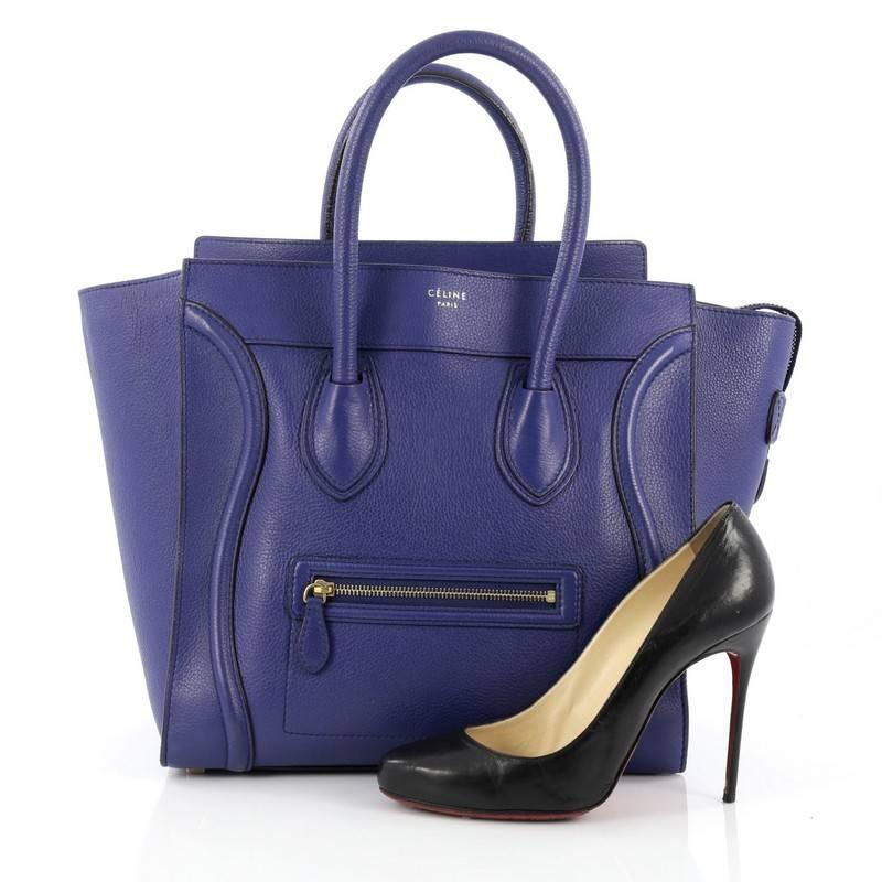 This authentic Celine Luggage Handbag Grainy Leather Mini epitomizes Phoebe Philo's minimalist yet chic style. Constructed in blue leather, this beloved fashionista's bag features dual-rolled leather handles, a frontal zip pocket, Celine's signature