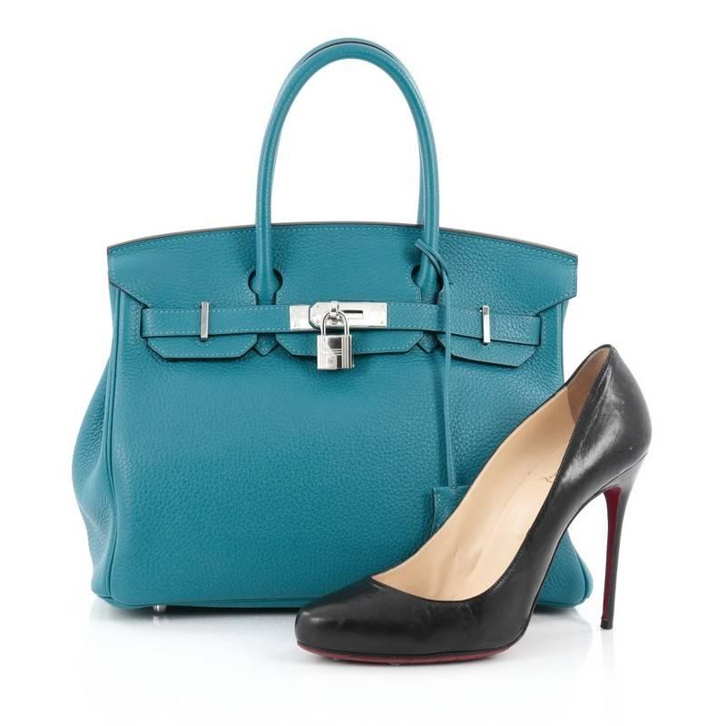 This authentic Hermes Birkin Handbag Blue Izmir Clemence with Palladium Hardware 30 stands as one of the most-coveted bags. Constructed in scratch-resistant, iconic blue izmir clemence leather, this stand-out tote features dual-rolled top handles,