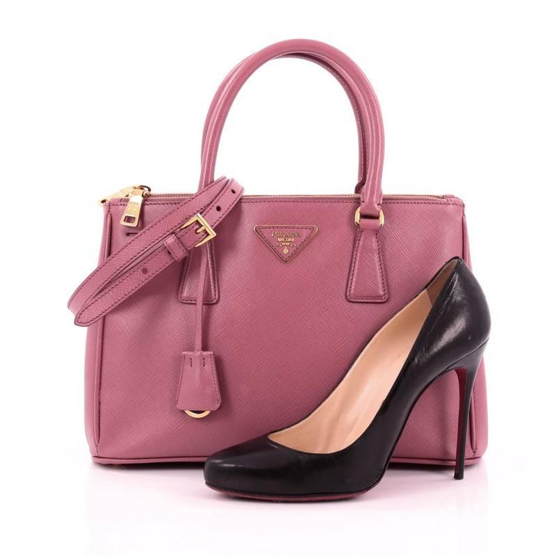 This authentic Prada Double Zip Lux Tote Saffiano Leather Small is the perfect bag to complete any outfit. Crafted from pink saffiano leather, this boxy tote features side snap buttons, raised Prada logo, dual-rolled leather handles, protective base