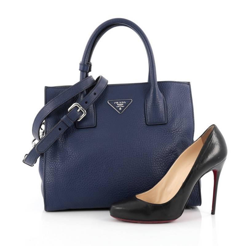 This authentic Prada Twin Shopping Tote Vitello Daino Medium is your perfect carry-all everyday bag. Crafted from blue vitello daino leather, this elegant, versatile tote features dual-rolled handles, side snaps that reveals expanded wings,