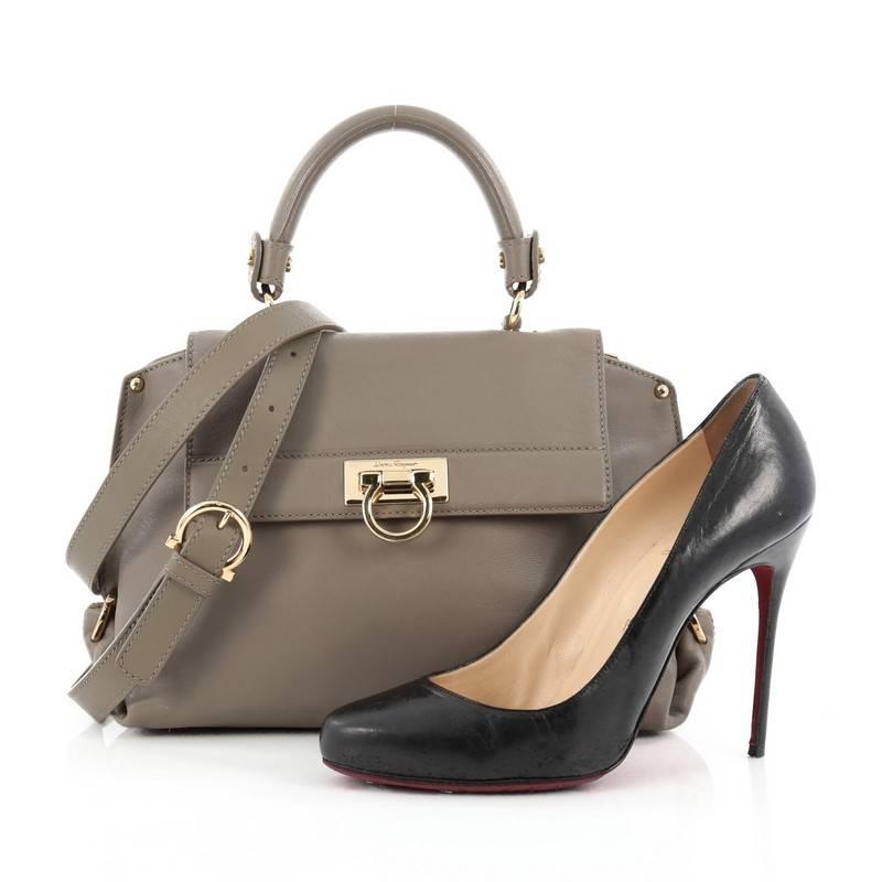 This authentic Salvatore Ferragamo Sofia Satchel Smooth Leather Small is stylish and functional. Crafted in grey smooth leather, this bag features a sturdy top handle with exterior back zip pocket, protective base studs and gold-tone hardware