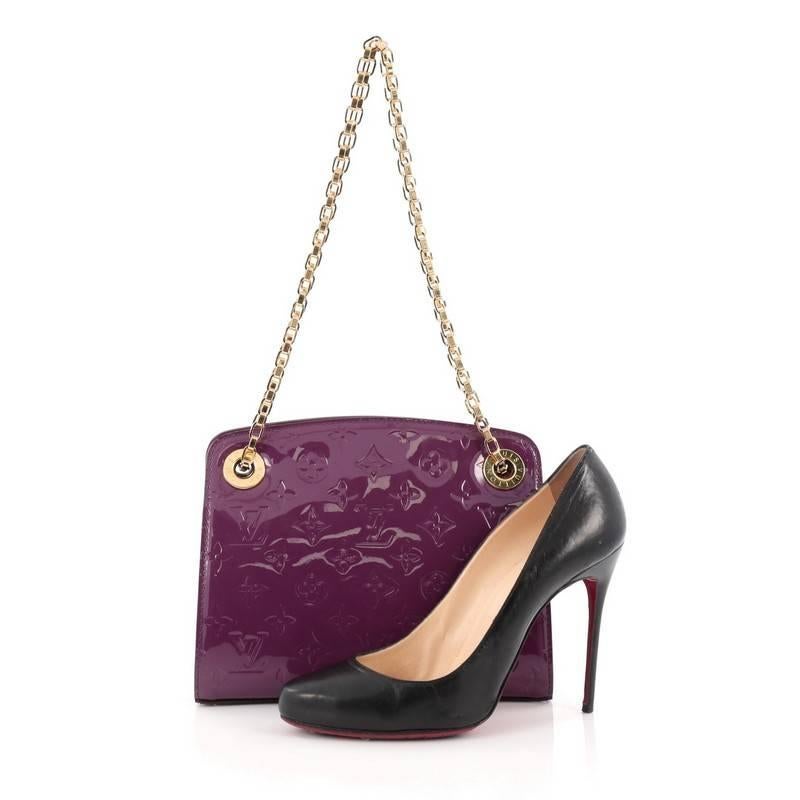 This authentic Louis Vuitton Virginia Handbag Monogram Vernis PM is perfect for the sophisticated woman. Crafted from amethyste purple monogram vernis leather, this simple and elegant bag features a shiny gold-tone chain link and eyelet straps,