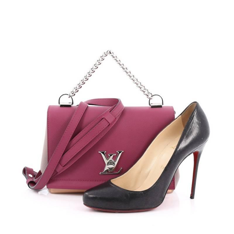 This authentic Louis Vuitton Lockme II Bag Leather BB presented in the brand's 2015 Collection is a must-have signature, city bag made for the modern woman. Crafted from multicolor leather, this chic bag features a short thick chain-link handle,