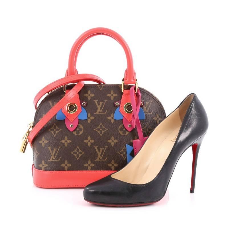 This authentic Louis Vuitton Alma Handbag Limited Edition Totem Monogram Canvas BB presented in the brand's Fall/Winter 2015 Collection updates its classic Alma with playful styling and is inspired by Gaston Vuitton's african tribal masks. Crafted
