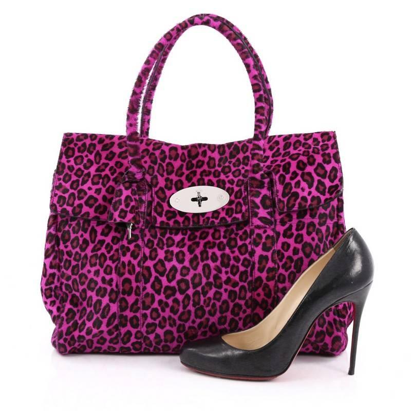 This authentic Mulberry Bayswater Satchel Calf Hair Medium showcases the brand's simple, iconic design with a fresh twist. Crafted from leopard print purple genuine calf hair, this industrial-style tote features tall dual-rolled leather handles,