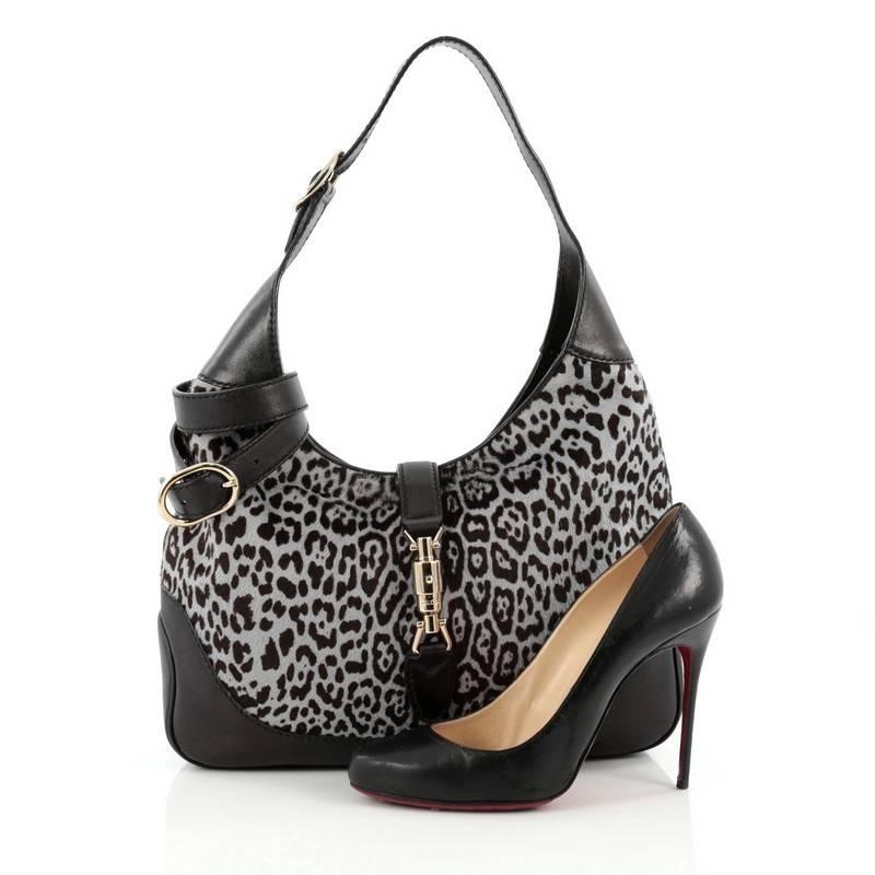 This authentic Gucci Jackie Original Shoulder Bag Pony Hair Medium is a must-have luxurious everyday shoulder bag fit for the modern woman. Crafted from greyish blue leopard print genuine pony hair and black leather, this re-imagined classic Jackie