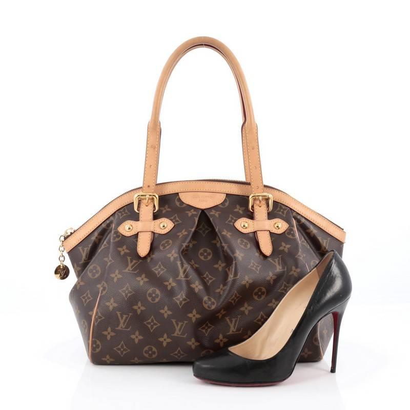 This authentic Louis Vuitton Tivoli Handbag Monogram Canvas GM inspired by the Italian city itself combines chic and feminine luxury for everyday use. Crafted from iconic brown monogram coated canvas, this tote features dual-rolled handles, cowhide