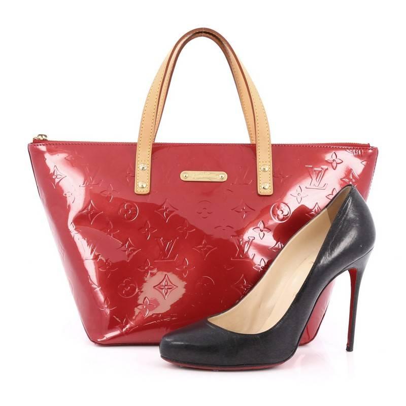 This authentic Louis Vuitton Bellevue Handbag Monogram Vernis PM is stylish yet functional tote perfect for everyday use. Crafted from Louis Vuitton's red monogram vernis embossed leather, this chic tote features dual flat vachetta leather handles,