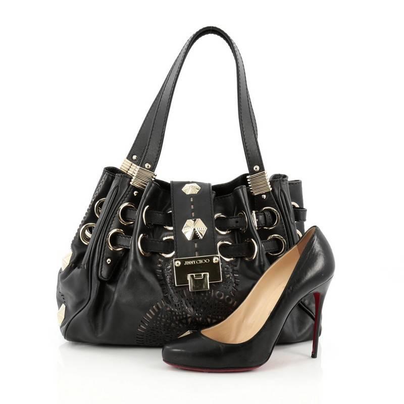 This authentic Jimmy Choo Riki Hobo Laser Cut Leather showcases a stylish bag perfect for the modern woman. Crafted in black leather, this eye-catching tote features tall dual flat leather handles, laser-cut logo detailing at front, unique