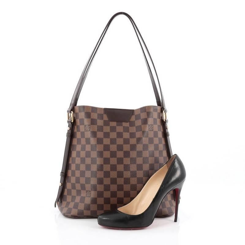 This authentic Louis Vuitton Cabas Rivington Damier has fashion and functionality all rolled into one. Crafted from damier ebene coated canvas with smooth chocolate leather trims, this chic bag features dual flat leather handles, two side zippers