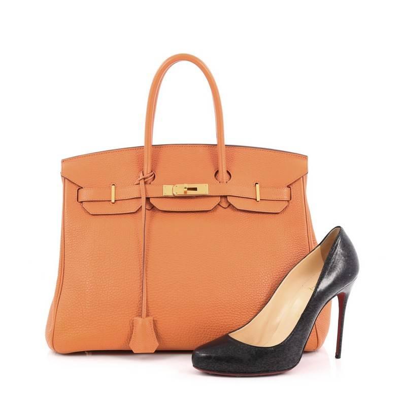 This authentic Hermes Birkin Handbag Orange Togo with Gold Hardware 35 stands as one of the most-coveted bags. Crafted from scratch-resistant, iconic orange togo leather, this stand-out tote features dual-rolled top handles, frontal flap, gold