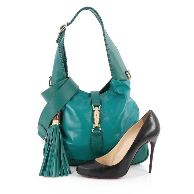This authentic Gucci New Jackie Handbag Leather Medium is a must-have luxurious everyday hobo fit for the modern woman. Crafted from turquoise leather, this re-imagined hobo features adjustable shoulder strap, side leather tassels with bamboo