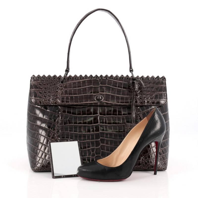 This authentic Bottega Veneta Tie-Dye Tiina Bag Crocodile Large is for the boldest of fashionistas featured in Bottega Veneta's Fall 2010 Collectio. Constructed with rich glossy brown genuine crocodile, the unique tie-dye is treated by hand creating