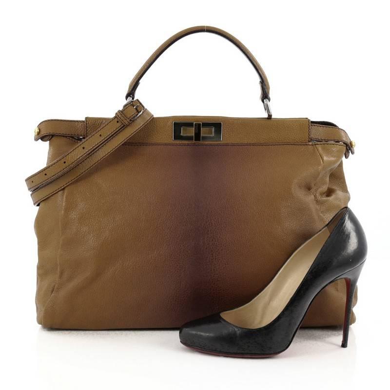 This authentic Fendi Peekaboo Handbag Leather with Calf Hair Interior Large is one of Fendi's best known design exuding a luxurious yet minimalist appearance. Crafted in brown leather, this versatile and stylish satchel features flat leather top