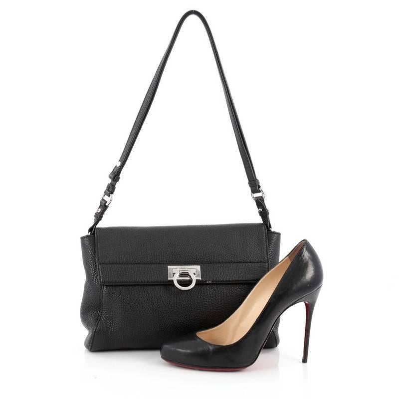 This authentic Salvatore Ferragamo Abbey Shoulder Bag Leather is perfect for woman on-the-go. Crafted in black pebbled leather, this shoulder bag features an adjustable shoulder leather strap, frontal flap with gancio lock closure and silver-tone