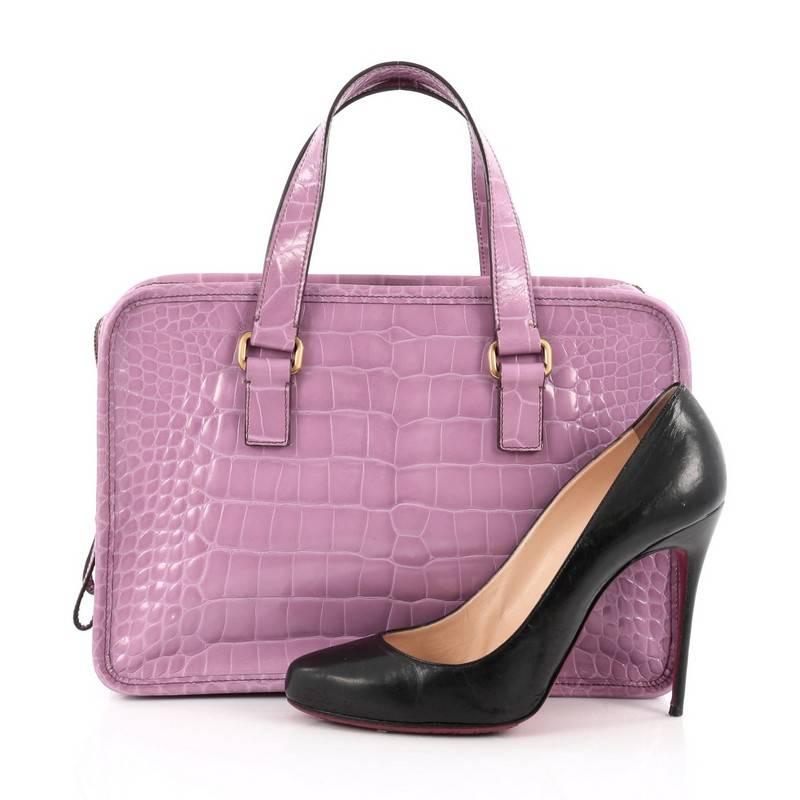 This authentic Prada St. Cocco Lucido Bauletto Handle Bag Crocodile Embossed Leather is sophisticated and unique perfect for modern fashionistas. Crafted in lilac crocodile embossed leather, this bag features dual-flat handles, iconic Prada logo and