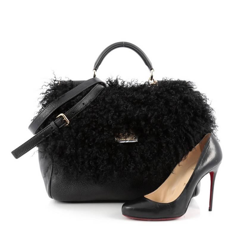 This authentic Dolce & Gabbana Miss Sicily Handbag Shearling Large updates its classic Miss Sicily bag with exotic flair. Designed in black genuine shearling and leather, this runway-ready satchel features a rolled top handle, engraved logo plaque,
