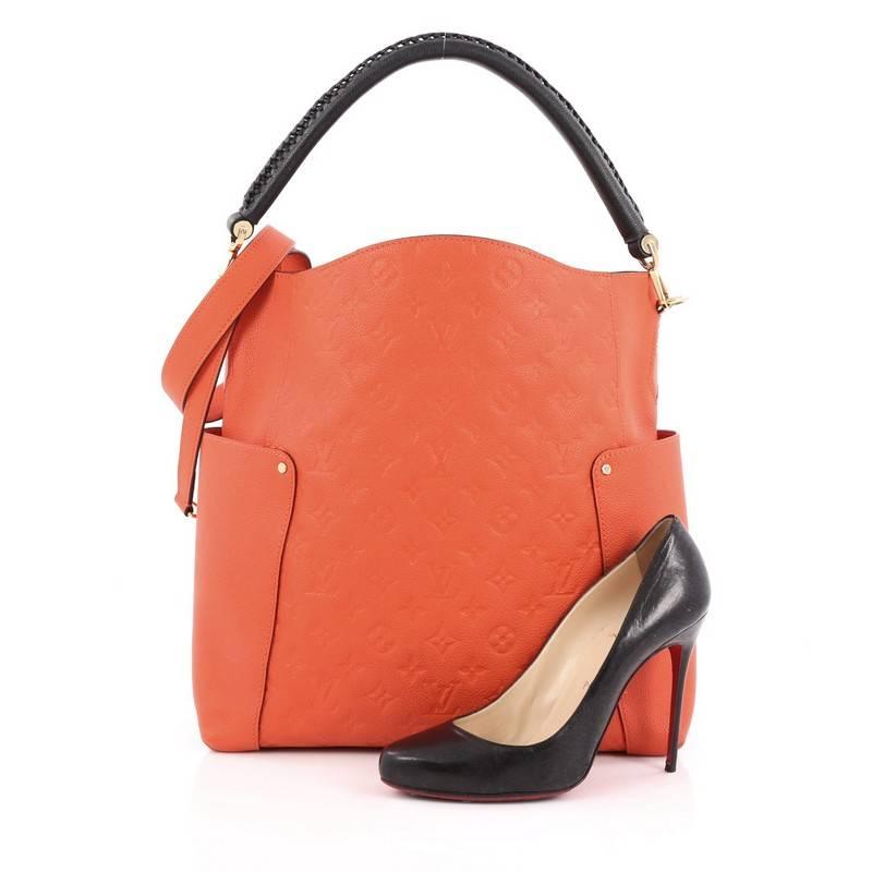 This authentic Louis Vuitton Bagatelle Hobo Monogram Empreinte Leather is a versatile and chic bag perfect for your everyday looks. Crafted from orange monogram empreinte leather with leather trims, this luxurious hobo features a braided handle,